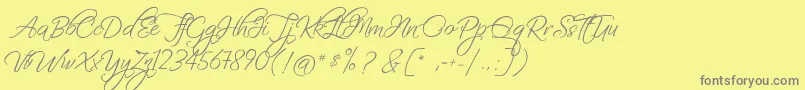 FascinatingChristmas-fontti – harmaat kirjasimet keltaisella taustalla