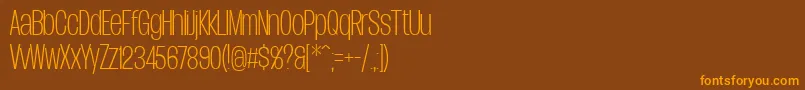 フォントDueraCondthinPersonal – オレンジ色の文字が茶色の背景にあります。