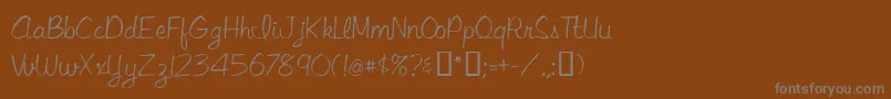 フォントLibbyscript – 茶色の背景に灰色の文字