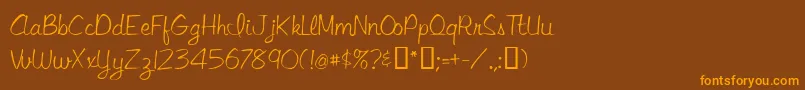 フォントLibbyscript – オレンジ色の文字が茶色の背景にあります。