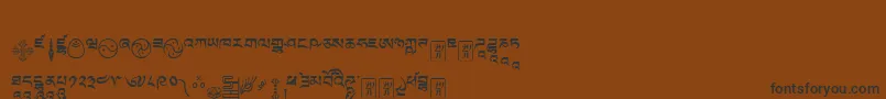 Tibetanmachineweb9-Schriftart – Schwarze Schriften auf braunem Hintergrund