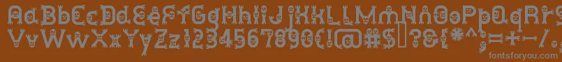 DusthomemanMedium-fontti – harmaat kirjasimet ruskealla taustalla