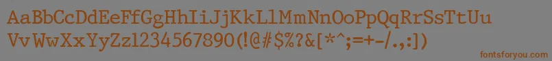 フォントPrestigeNormalRegular – 茶色の文字が灰色の背景にあります。