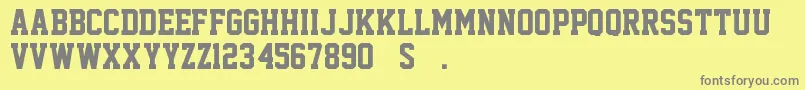 SuperstarM54-fontti – harmaat kirjasimet keltaisella taustalla