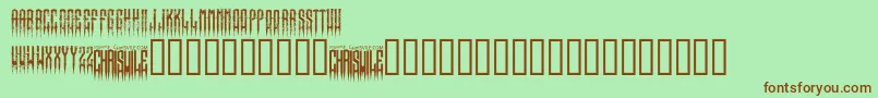 フォントXspikedRegular – 緑の背景に茶色のフォント