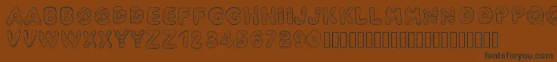 Шрифт Pwyummydonuts – чёрные шрифты на коричневом фоне