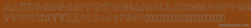フォントPwyummydonuts – 茶色の背景に灰色の文字