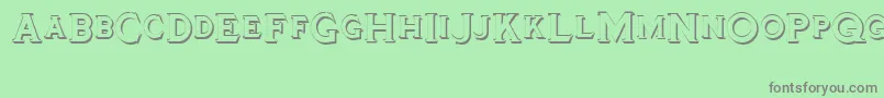 Tinplatetitlingshadowed-fontti – harmaat kirjasimet vihreällä taustalla