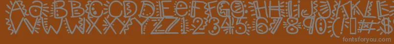 Manicpopthrill-fontti – harmaat kirjasimet ruskealla taustalla