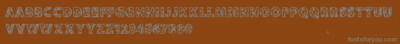 フォントVtksskulls – 茶色の背景に灰色の文字