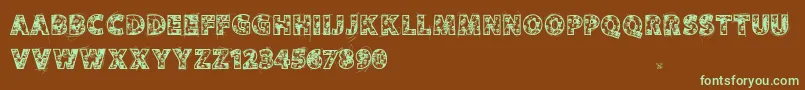 フォントVtksskulls – 緑色の文字が茶色の背景にあります。