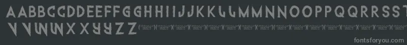 Intothegatorpit-fontti – harmaat kirjasimet mustalla taustalla