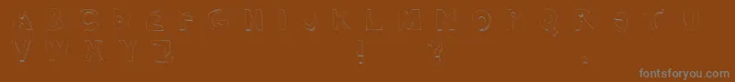 フォントTexasJigsawMassacre – 茶色の背景に灰色の文字