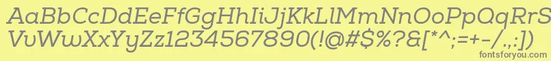 NexaSlabRegularItalic-fontti – harmaat kirjasimet keltaisella taustalla