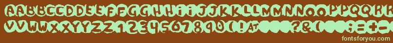 フォントPotassiumScandal – 緑色の文字が茶色の背景にあります。