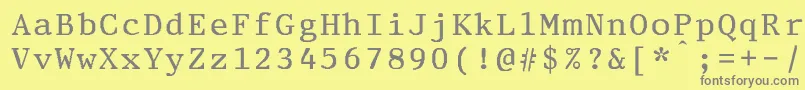 PrestigeeliteboldBold-fontti – harmaat kirjasimet keltaisella taustalla