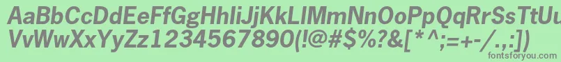 NewsgothicstdBoldoblique-fontti – harmaat kirjasimet vihreällä taustalla