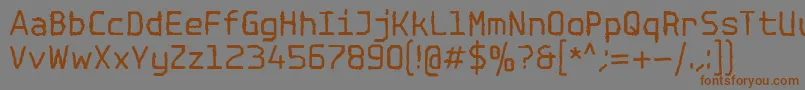 フォントSpotlightTypewriterNc – 茶色の文字が灰色の背景にあります。