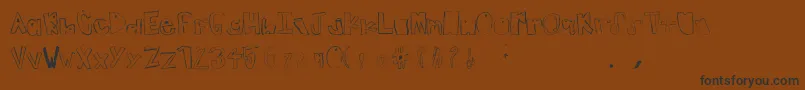 フォントTeenageDream – 黒い文字が茶色の背景にあります