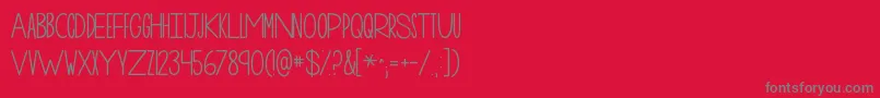 フォントKgonemorenight – 赤い背景に灰色の文字