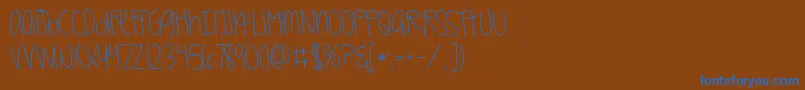 Kggirlonfire-Schriftart – Blaue Schriften auf braunem Hintergrund