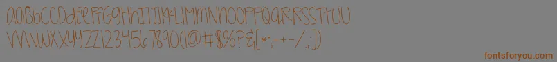 Kggirlonfire-Schriftart – Braune Schriften auf grauem Hintergrund