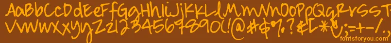 Czcionka DjbSmartyPants – pomarańczowe czcionki na brązowym tle