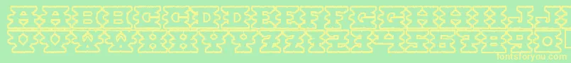 フォントMontezumaancient – 黄色の文字が緑の背景にあります
