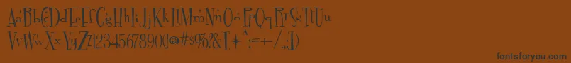フォントFontdinerdotcom Sparkly – 黒い文字が茶色の背景にあります