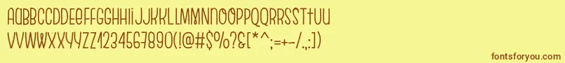 フォントEscalopeCrustThree – 茶色の文字が黄色の背景にあります。