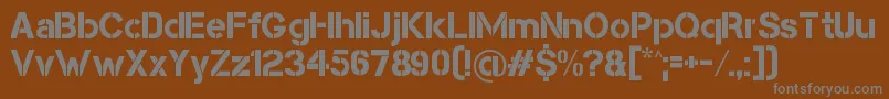 CapsmallClean-fontti – harmaat kirjasimet ruskealla taustalla