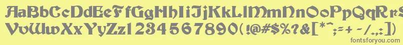 フォントTutburB – 黄色の背景に灰色の文字