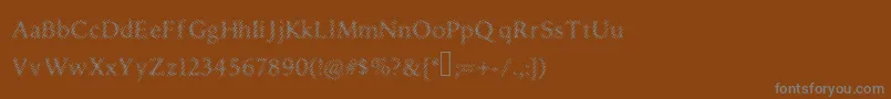 Czcionka Druggedindividualist – szare czcionki na brązowym tle