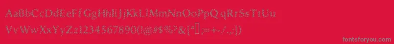 フォントDruggedindividualist – 赤い背景に灰色の文字