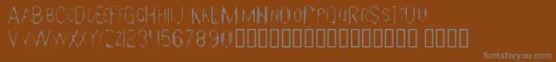 GloomyGus-fontti – harmaat kirjasimet ruskealla taustalla