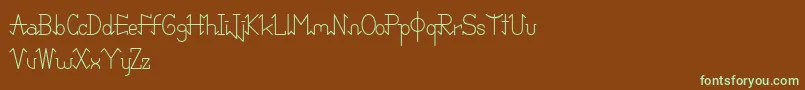 フォントPixoDemo – 緑色の文字が茶色の背景にあります。