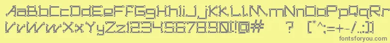 フォントDogonsTribe – 黄色の背景に灰色の文字