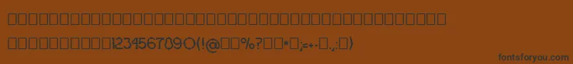 OgradaNormal-Schriftart – Schwarze Schriften auf braunem Hintergrund