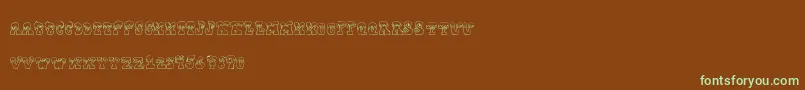 フォントFrostyholiday – 緑色の文字が茶色の背景にあります。
