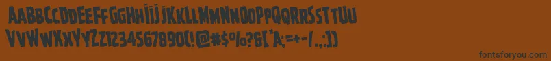 フォントGhoulishintentrotate – 黒い文字が茶色の背景にあります