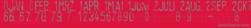 フォントLinotypeTagesstempelMager – 赤い背景に灰色の文字