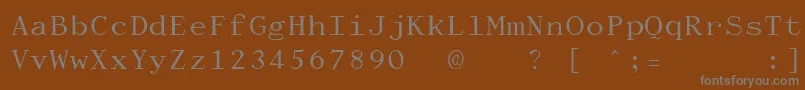 DactylographeUnregistered-fontti – harmaat kirjasimet ruskealla taustalla