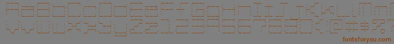 フォントStashOfDashes – 茶色の文字が灰色の背景にあります。