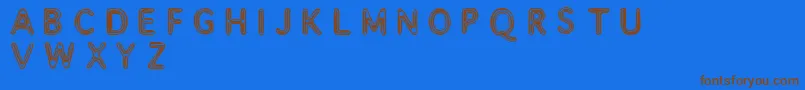 Assimilate Font – Brown Fonts on Blue Background