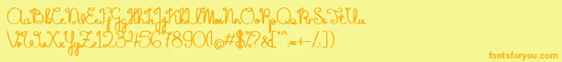 フォントTheFlowerySpring – オレンジの文字が黄色の背景にあります。