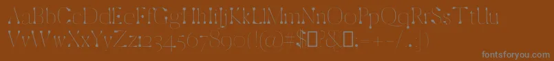 ZackThin-fontti – harmaat kirjasimet ruskealla taustalla