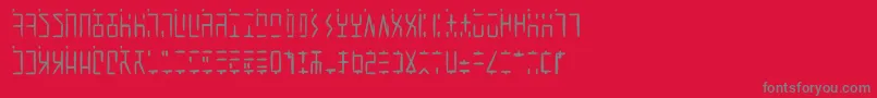AncientGWritten-fontti – harmaat kirjasimet punaisella taustalla