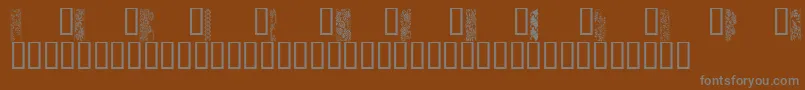 JapaneseBorders-fontti – harmaat kirjasimet ruskealla taustalla