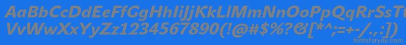 JohnsansHeavyProItalic-fontti – harmaat kirjasimet sinisellä taustalla