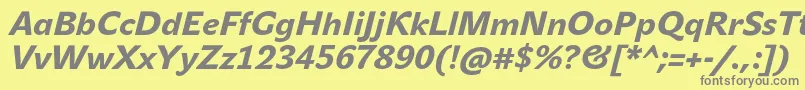 JohnsansHeavyProItalic-fontti – harmaat kirjasimet keltaisella taustalla